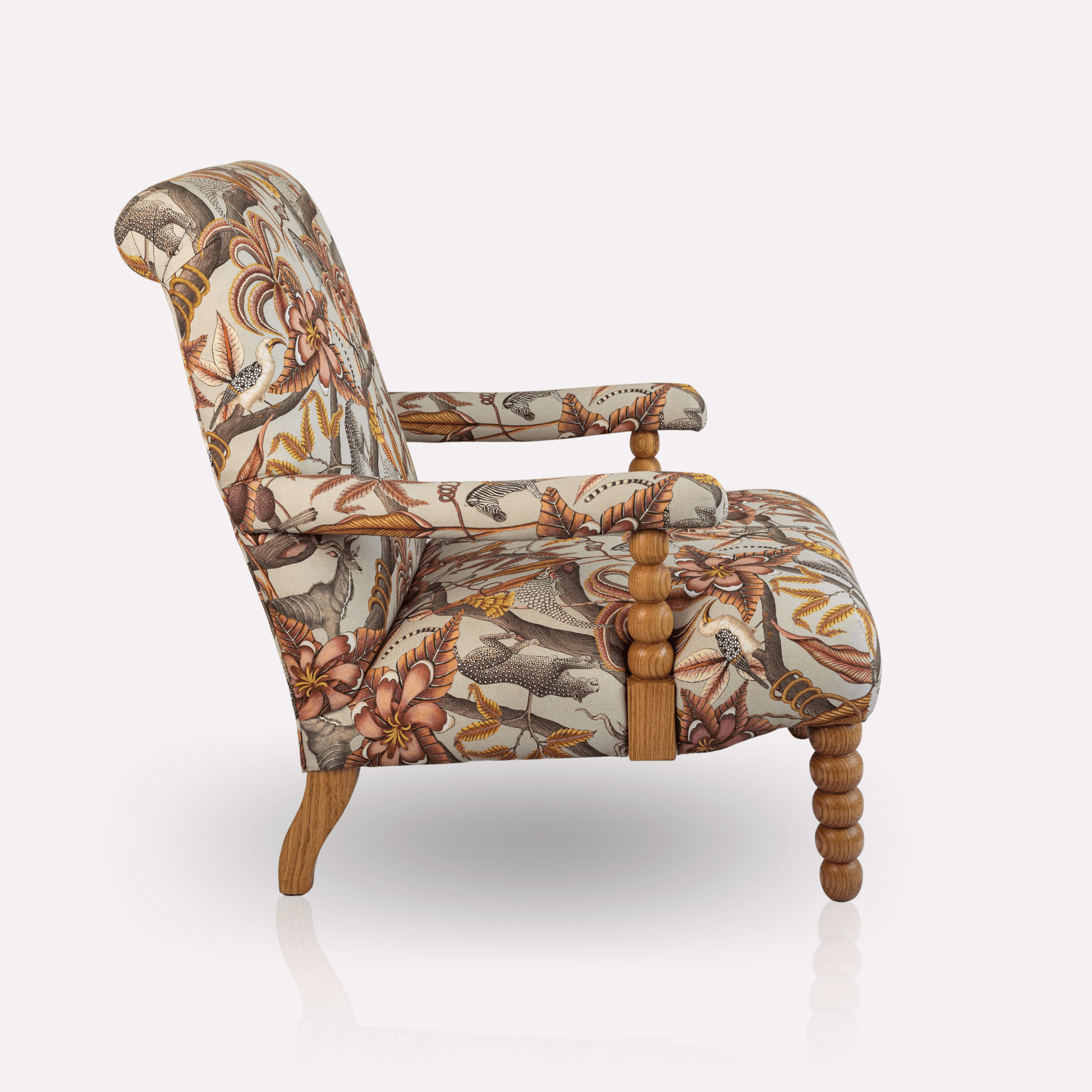 Side angle of the Ardmore Kudu Pod Chair in Pangolin Plum Velvet, emphasising its contoured wooden legs, plush seating, and expertly tailored fabric.