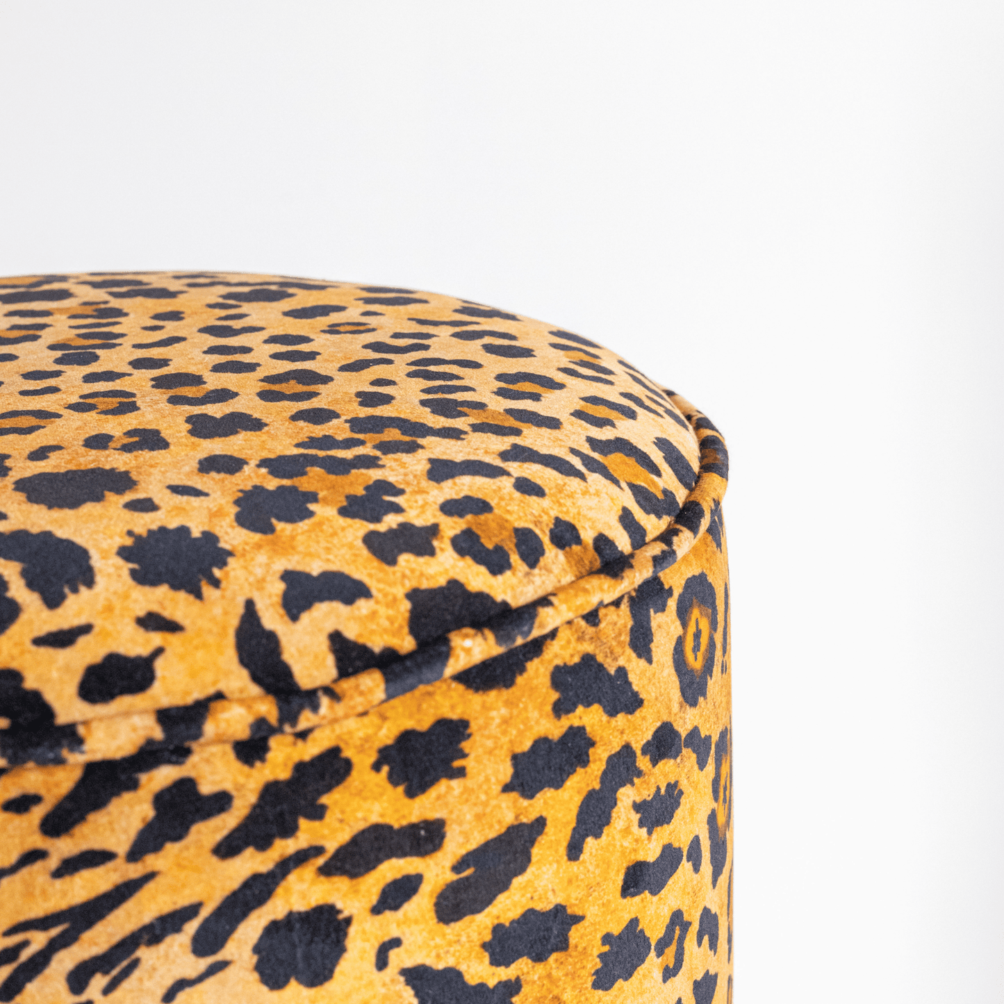 A closer look at the plush velvet upholstery, highlighting the intricate details and luxurious texture of the Safari Spot Gold pattern.