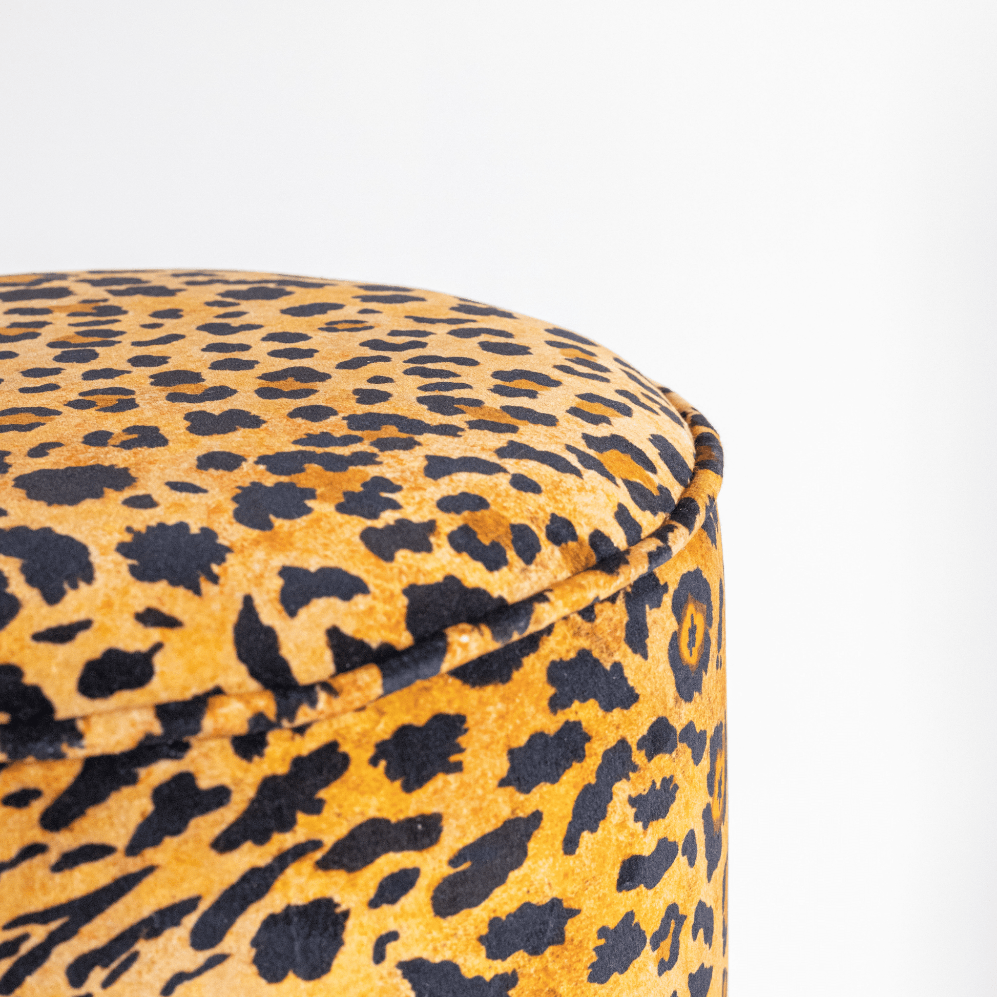 A closer look at the plush velvet upholstery, highlighting the intricate details and luxurious texture of the Safari Spot Gold pattern.