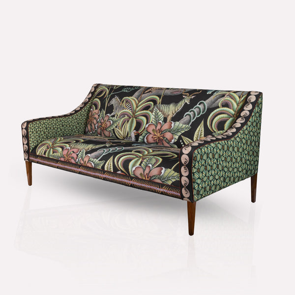 Front-facing view of the Ardmore Thanda Sofa Limited Edition, showcasing its elegant Pangolin Park design on matt black linen with Kiaat wooden legs.