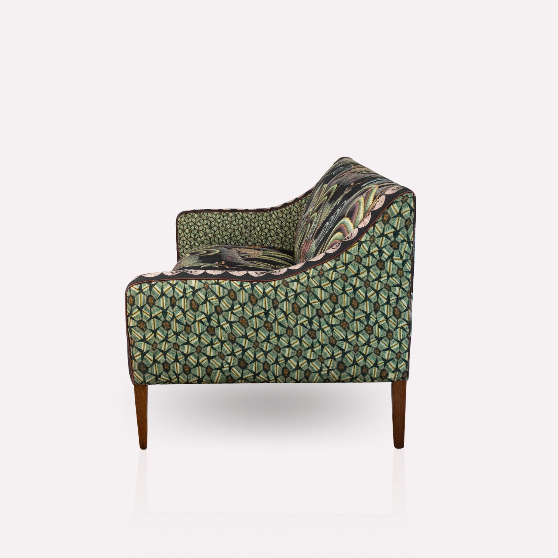 Angled view of the Ardmore Thanda Sofa Limited Edition, highlighting its curved armrests and intricate artistic patterns.