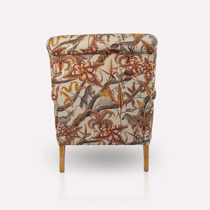 Angled perspective of the Ardmore Kudu Pod Chair in Pangolin Plum Velvet, capturing its elegant silhouette, plush comfort, and timeless African-inspired design.