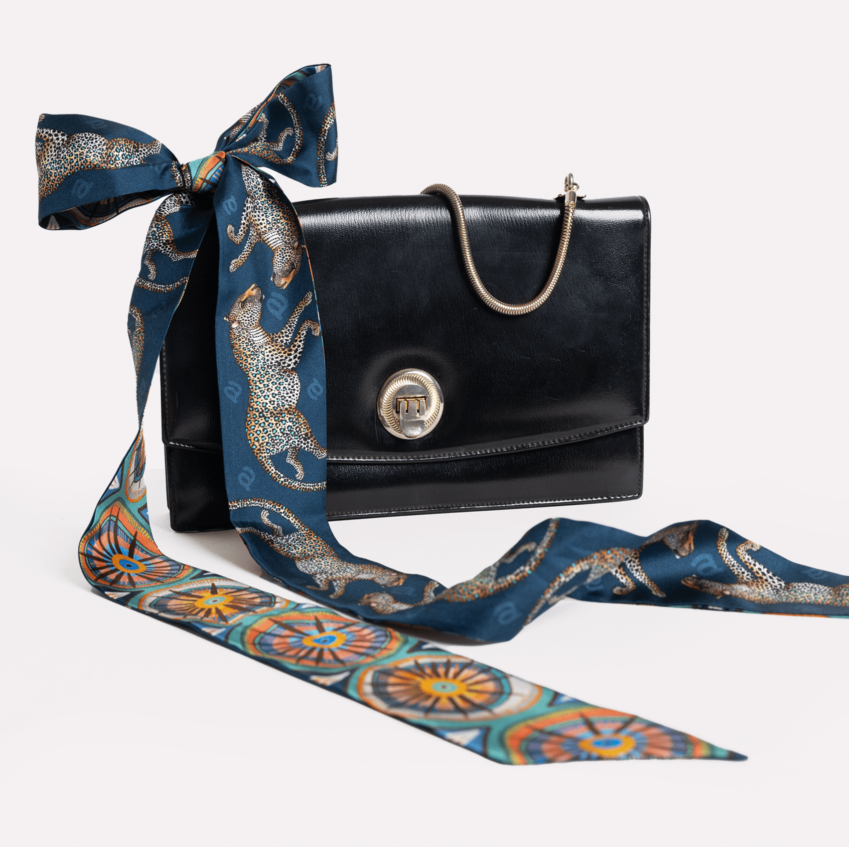 The twilly artistically tied into a bow, illustrating different ways to wear or style the accessory.