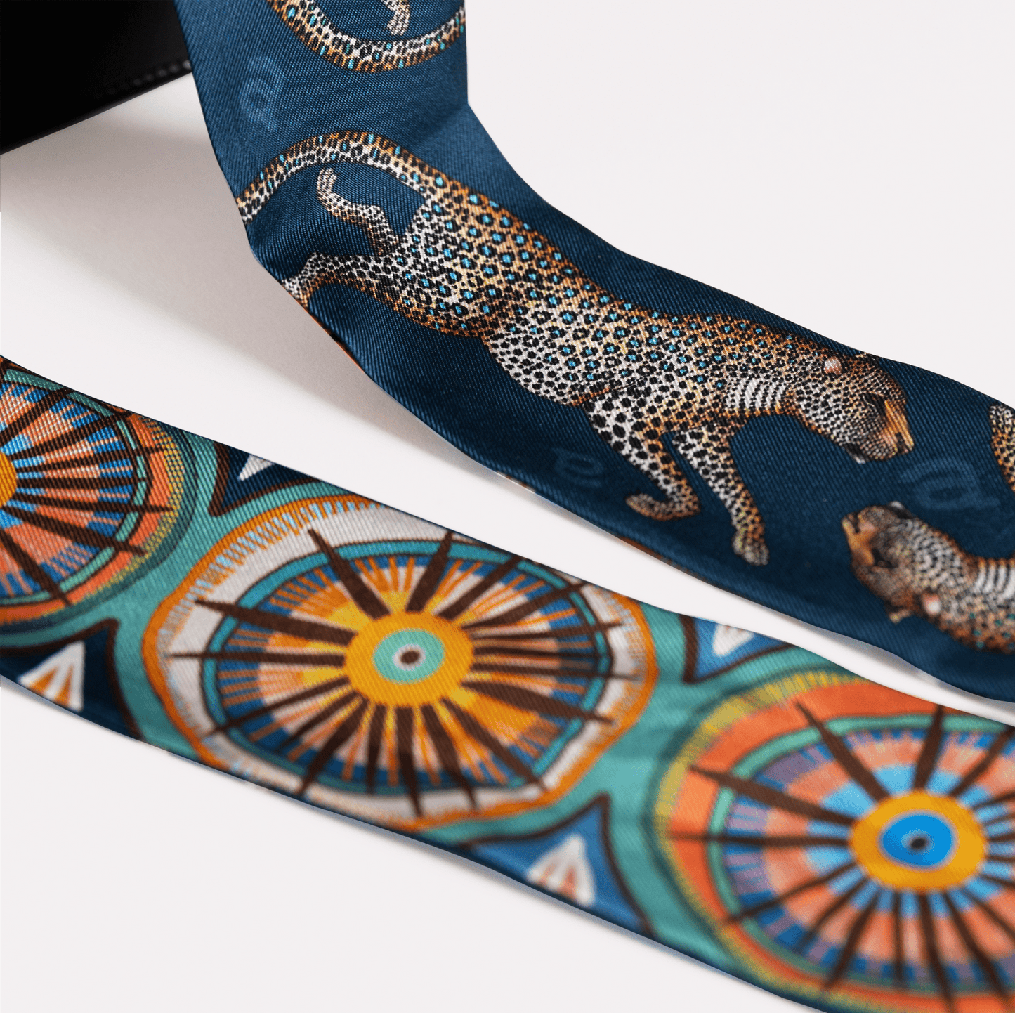 A detailed view of the luxurious silk fabric, highlighting the intricacy of the golden leopard pattern.