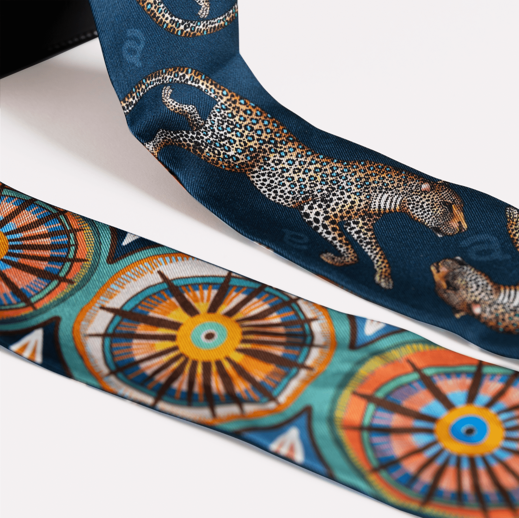 A detailed view of the luxurious silk fabric, highlighting the intricacy of the golden leopard pattern.