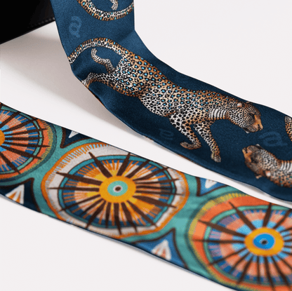 A detailed view of the luxurious silk fabric, highlighting the intricacy of the golden leopard pattern.