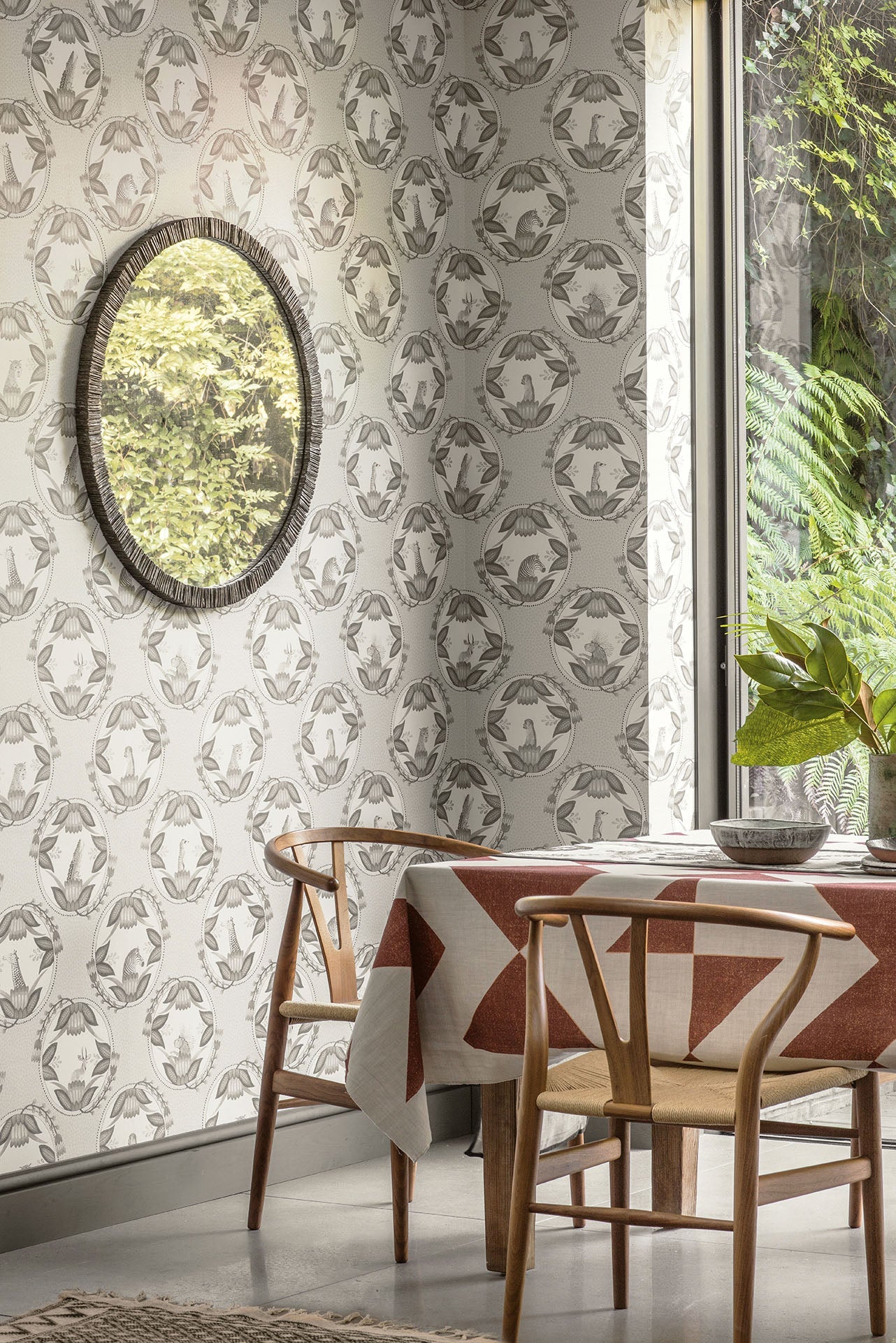 A beautifully styled interior setting featuring the soft olive green Cameos Wallpaper, illustrating its versatility and harmonious integration into refined décor.