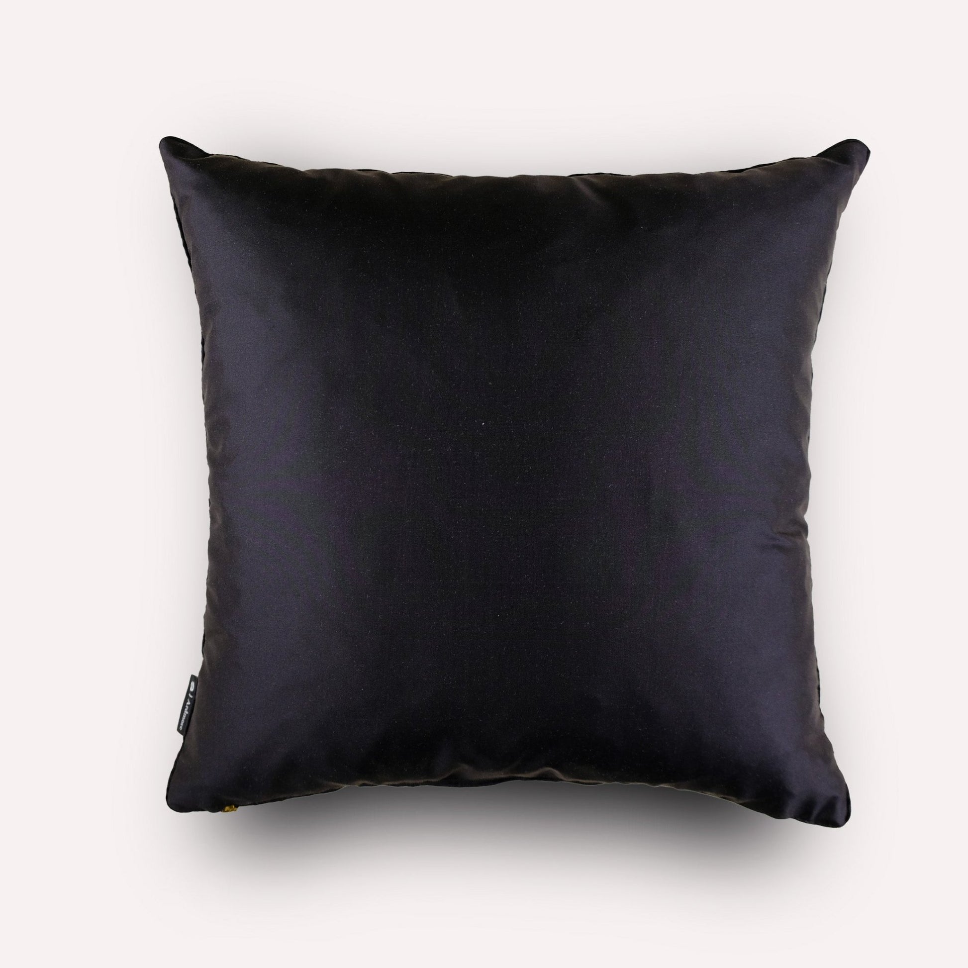 Back view of the Thanda Pangolin in Night Silk Cushion Cover, featuring plain black silk with refined piping detail.