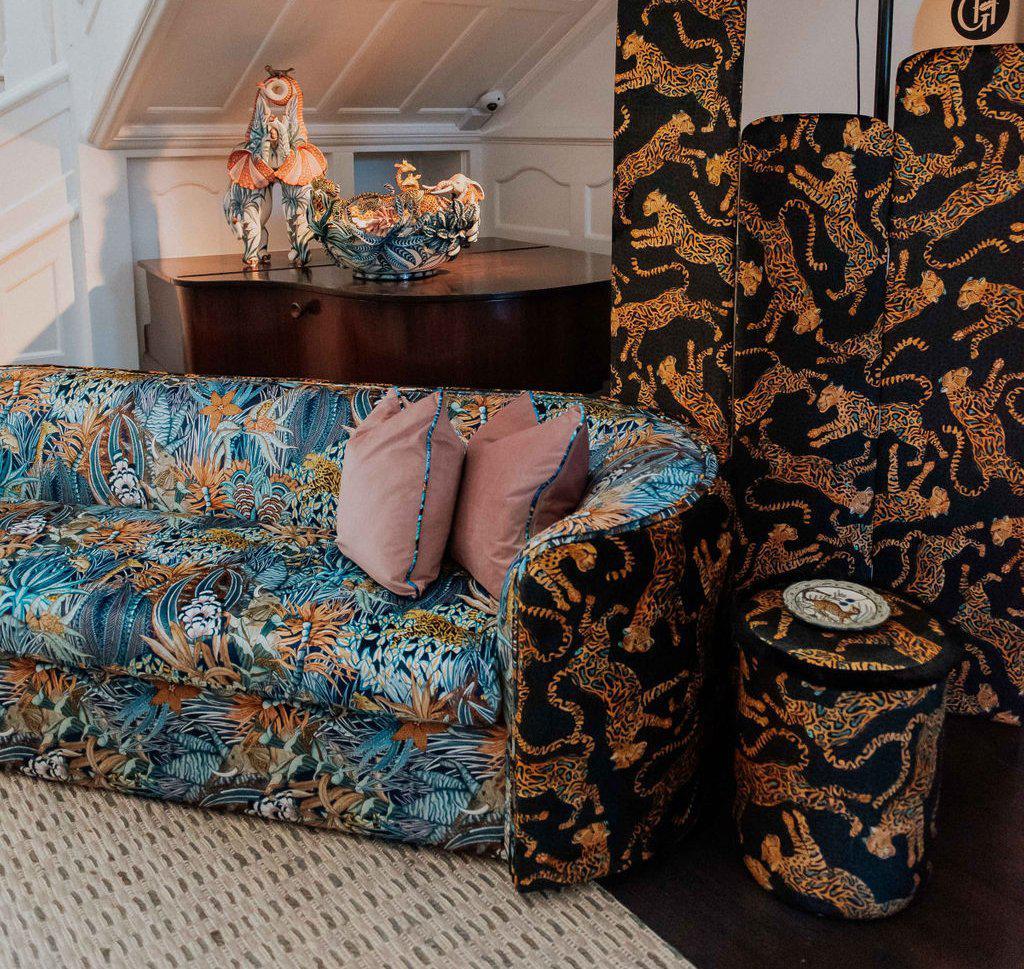 Interior setting featuring the Ardmore Cheetah Kings Amber Velvet Pouffe, beautifully integrated into a stylish living space alongside matching home decor pieces.