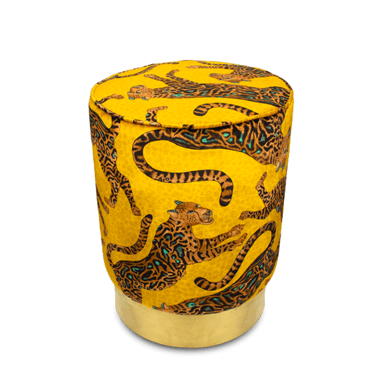 Luxurious Ardmore Cheetah Kings Gold Velvet Pouffe, featuring an opulent golden velvet fabric adorned with intricate black cheetah motifs, set on a gleaming brass base.