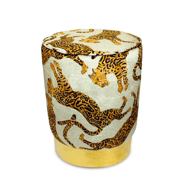 Elegant velvet pouffe adorned with Ardmore's Cheetah Kings Stone design, showcasing intricate cheetah motifs in rich golden hues against a stone-coloured background, set on a gleaming brass base.