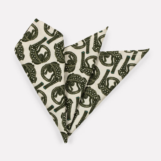 A set of Ardmore Croco napkins in Charcoal on Bleached, elegantly folded into a fan shape to showcase the bold crocodile-inspired print in black and white.