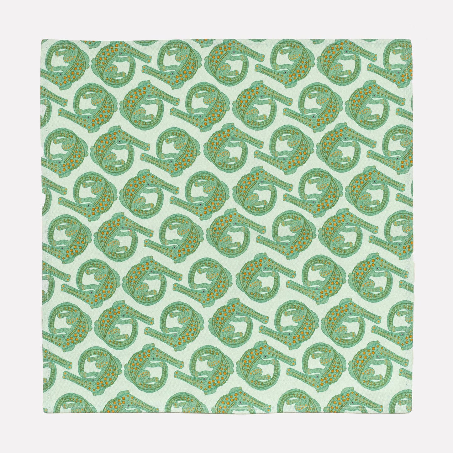 A full view of the Ardmore Croco napkin in Mist, showcasing the intricate repeating crocodile motif in a gentle green shade on a linen-cotton fabric blend.