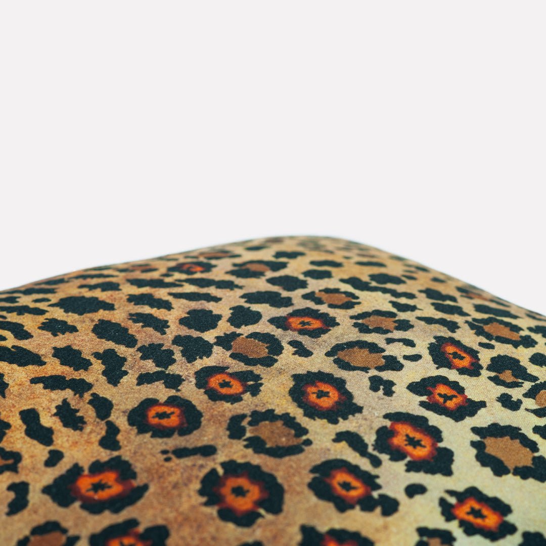 Side view of the Thanda Safari Spot Gold Cushion Cover, illustrating its sleek edges and high-quality cotton material.