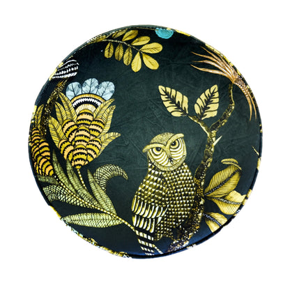 Top-down view of the Ardmore Camp Critter Dusk Velvet Pouffe, highlighting the vibrant golden floral and animal patterns against the rich green velvet background