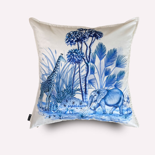 Front view of the Thanda Toile Tanzanite Velvet Cushion Cover, featuring a white background with a toile design in deep tanzanite blue, depicting an African wildlife scene with an elephant resting among lush foliage.