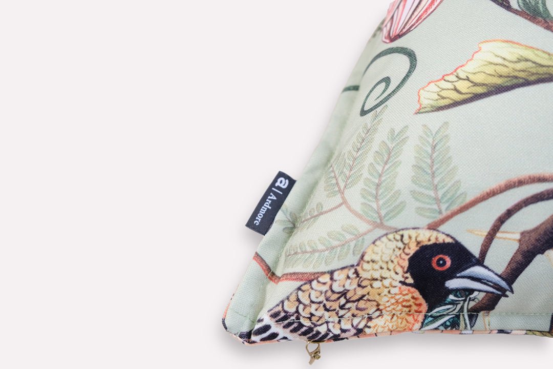 Side angle of the Thanda Nests Delta Outdoor Cushion Cover, highlighting its detailed floral and fauna-inspired design.