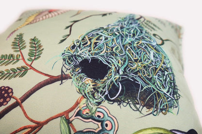 Close-up shot of the Thanda Nests Delta Outdoor Cushion Cover, showing the delicate illustrations and quality stitching.