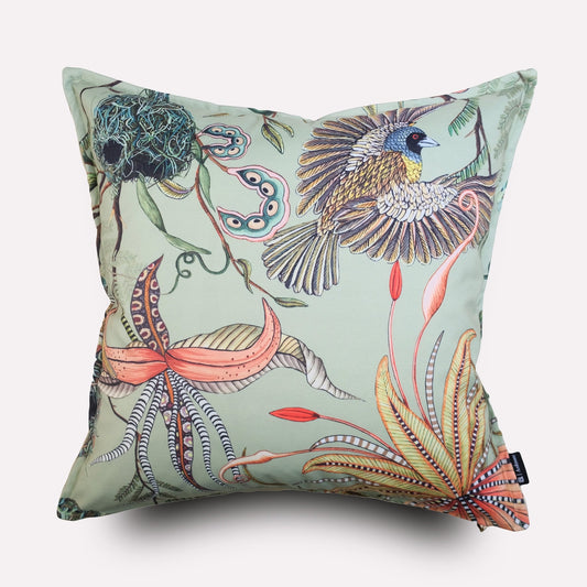 Front view of the Thanda Nests Delta Outdoor Cushion Cover, featuring a soft pastel green background with intricate botanical and bird nest-inspired artwork in shades of blue, orange, and brown