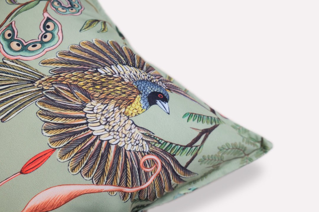 Close-up of the corner of the Thanda Nests Delta Outdoor Cushion Cover, showing the intricate pattern details, stitching, and the branded fabric tag.