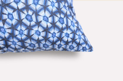 Close-up of the Thanda Tortoise Tanzanite Cushion Cover, highlighting the intricate blue patterned design and fabric texture on the cushion's corner.