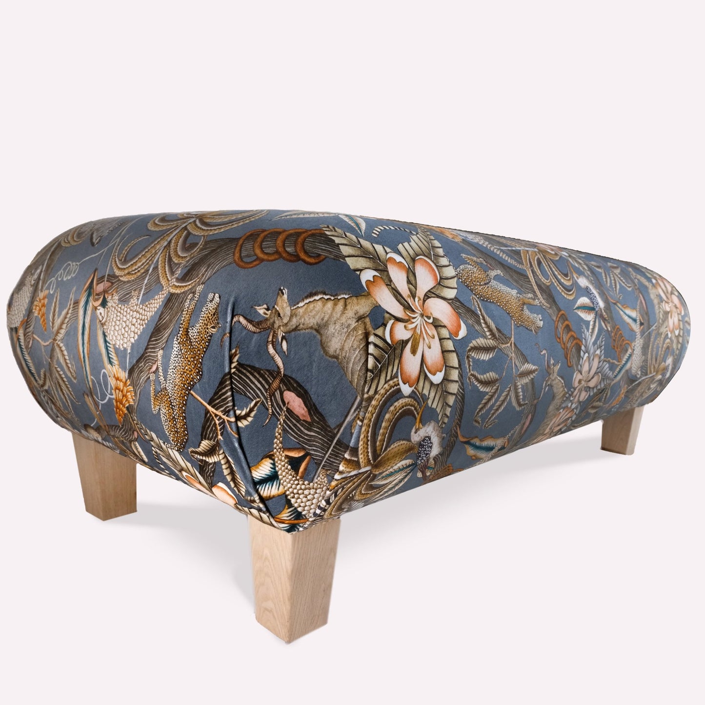 Showcasing the ottoman’s elegant curves, plush upholstery, and hand-finished wooden legs, adding a refined African charm to any living space.