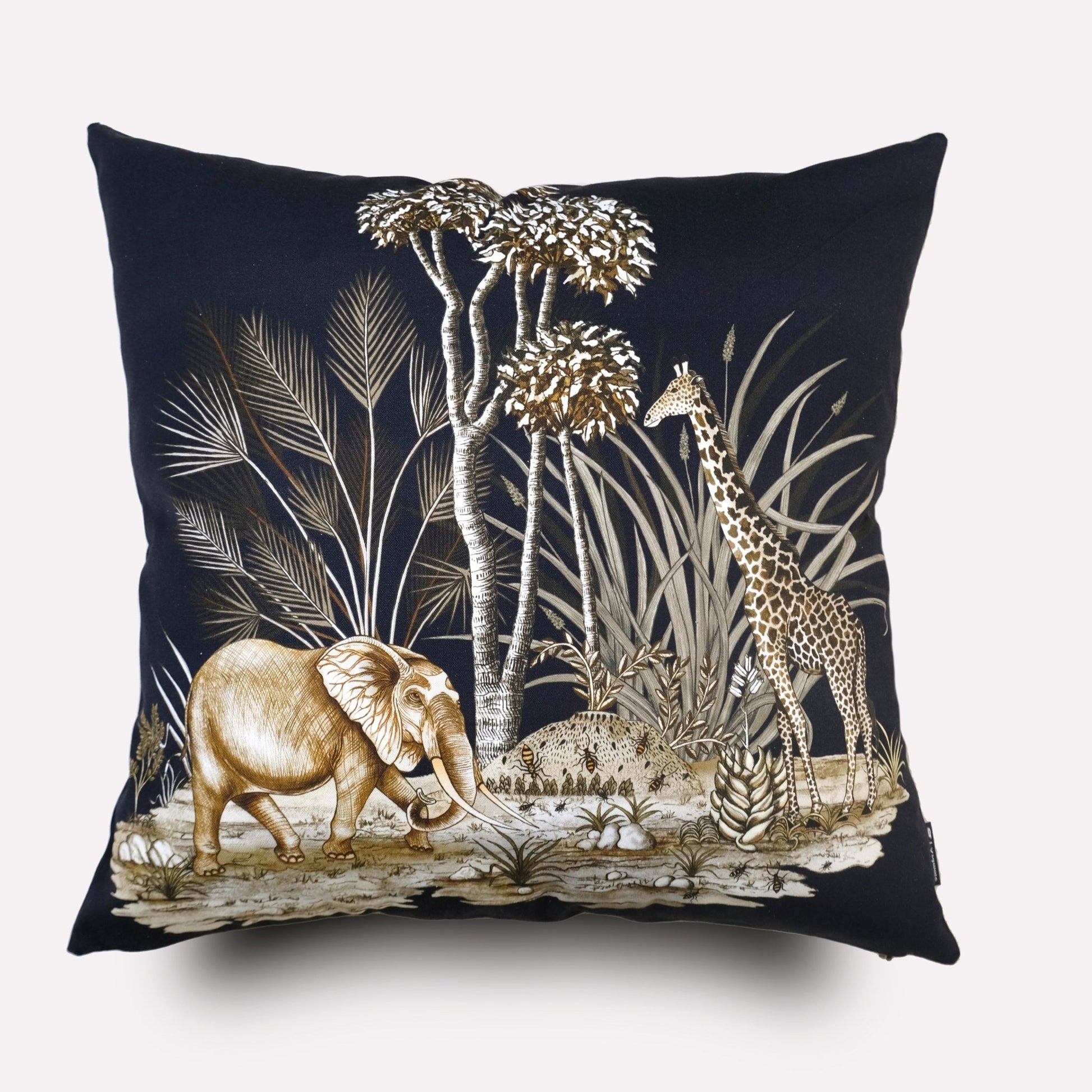 A luxurious square cushion cover with a dark navy velvet background, featuring an intricate wildlife design of an elephant surrounded by lush foliage and delicate botanical details.