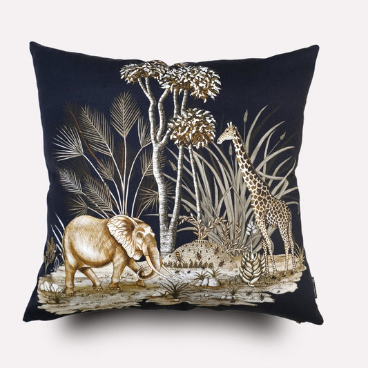 A luxurious square cushion cover with a dark navy velvet background, featuring an intricate wildlife design of an elephant surrounded by lush foliage and delicate botanical details.
