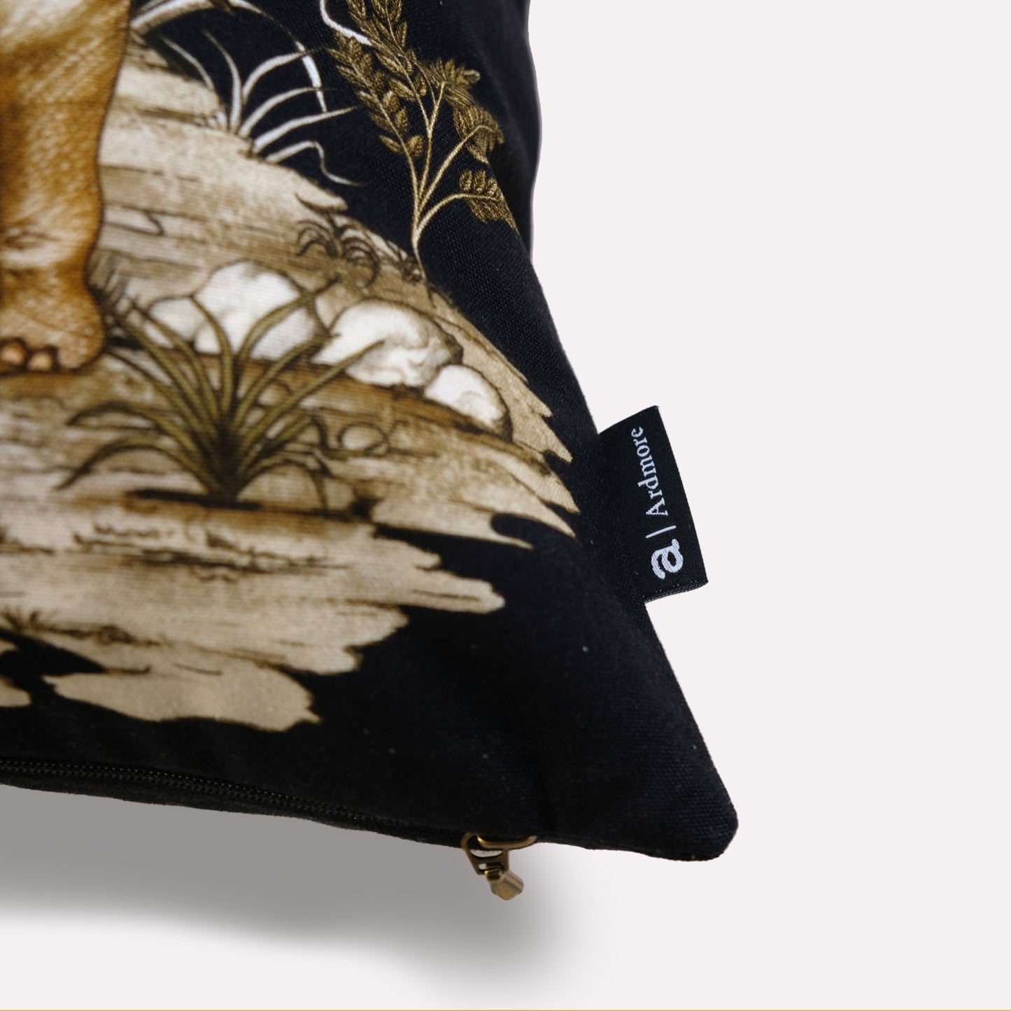A close-up of the cushion’s tag, showing the designer branding along with the deep, elegant velvet texture.