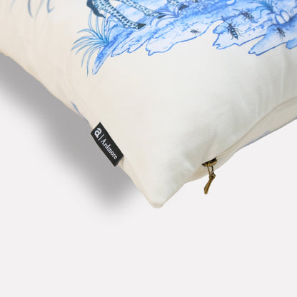 A side-angle shot of the cushion, highlighting the detailed botanical illustrations and vibrant blue color on the soft fabric.