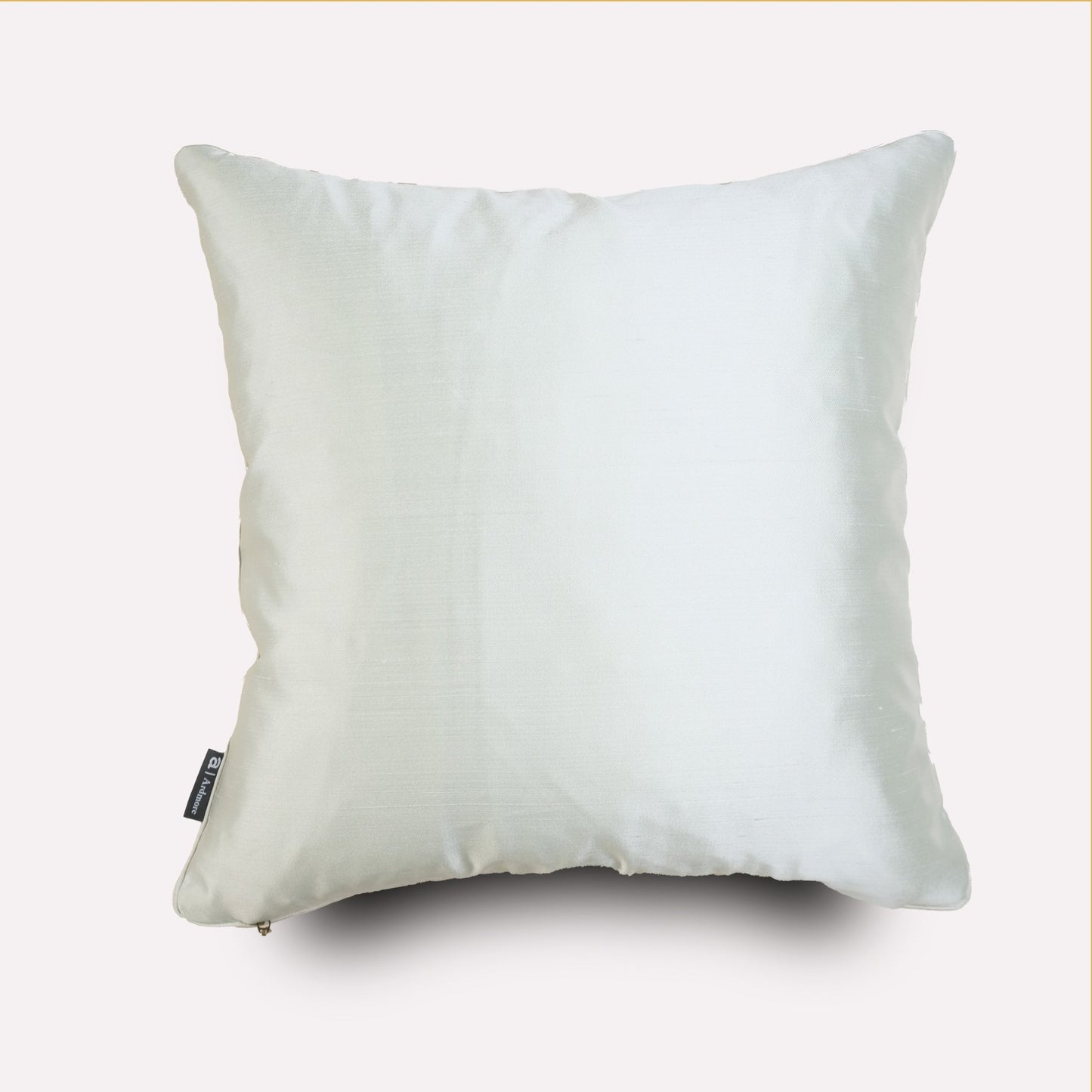 The reverse side of the cushion, showcasing a plain white silk fabric with smooth texture and elegant piping.