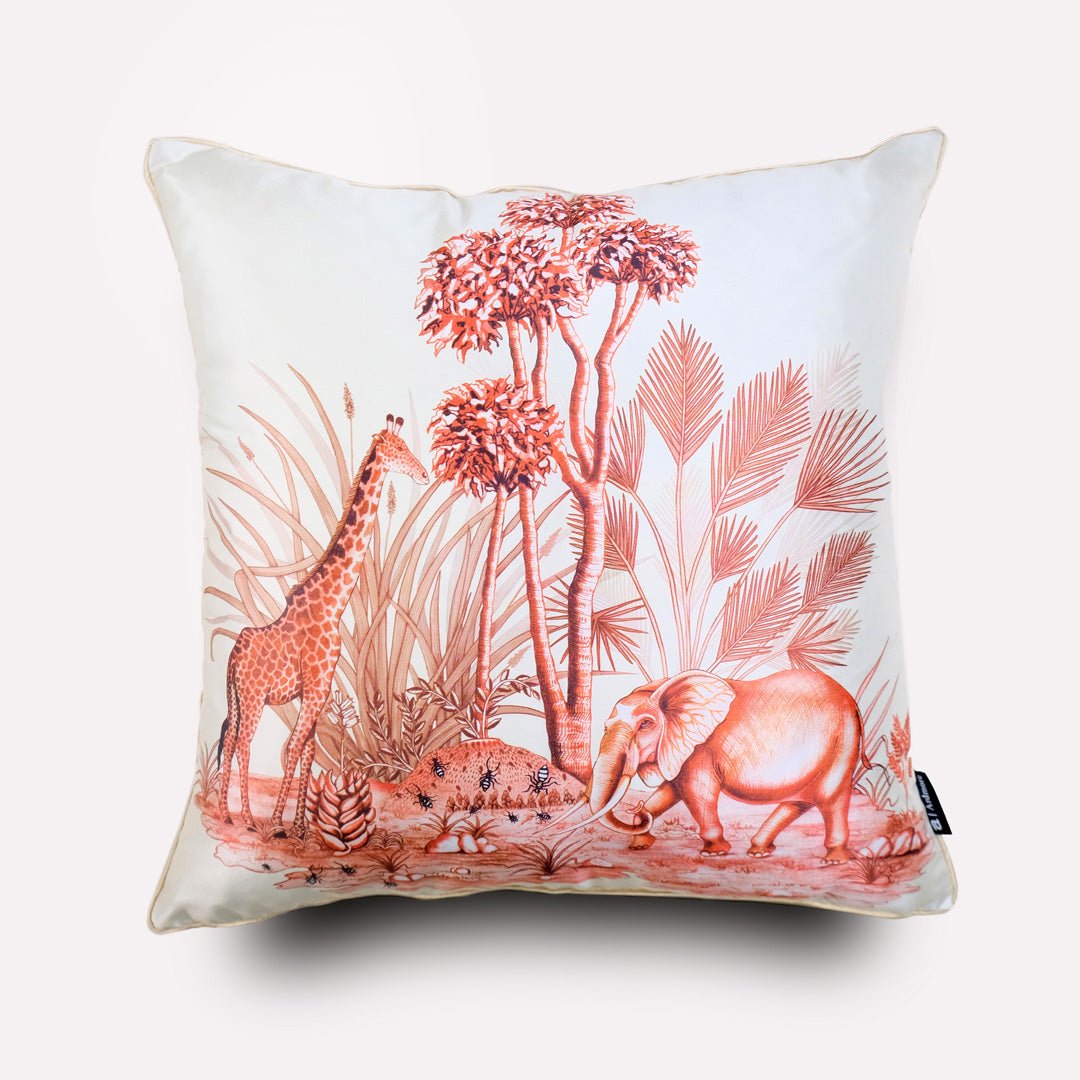 A white silk cushion cover featuring an elegant plum-coloured wildlife illustration, depicting elephants, giraffes, and African flora in intricate detail.