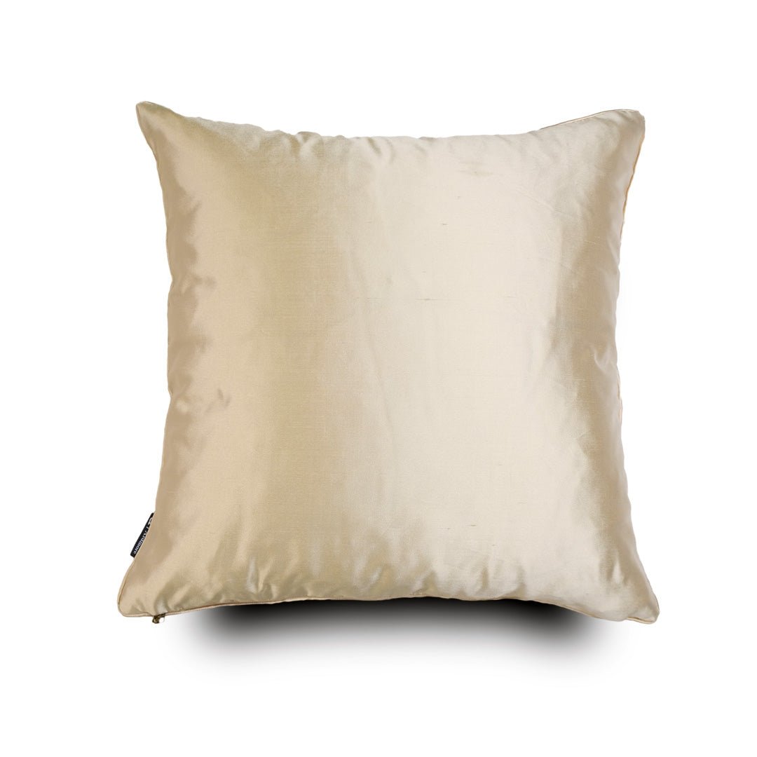The reverse side of the cushion, showcasing a plain, smooth-textured silk fabric in a neutral tone, finished with refined piping.