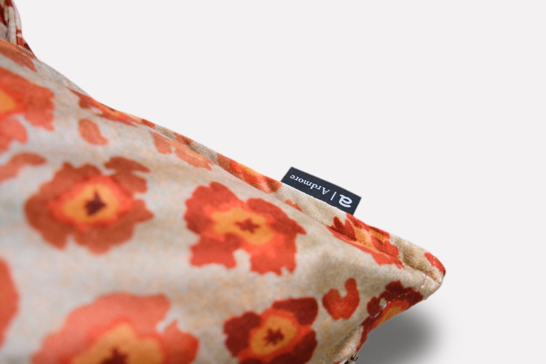 Close-up side view of the Safari Spot Coral Velvet Cushion Cover, featuring intricate details of the leopard-print design and high-quality stitching.