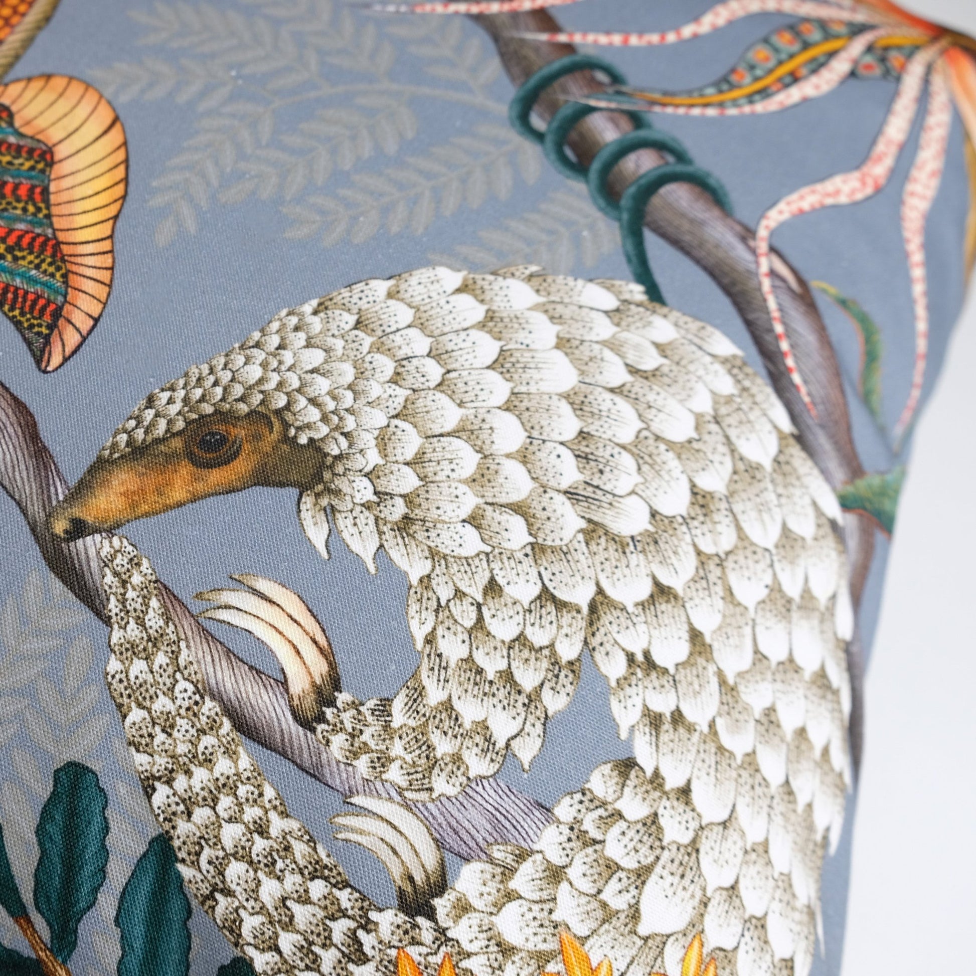 Side angle of the Thanda Pangolin in Ash Velvet Cushion Cover, highlighting the intricate stitching and premium velvet texture.