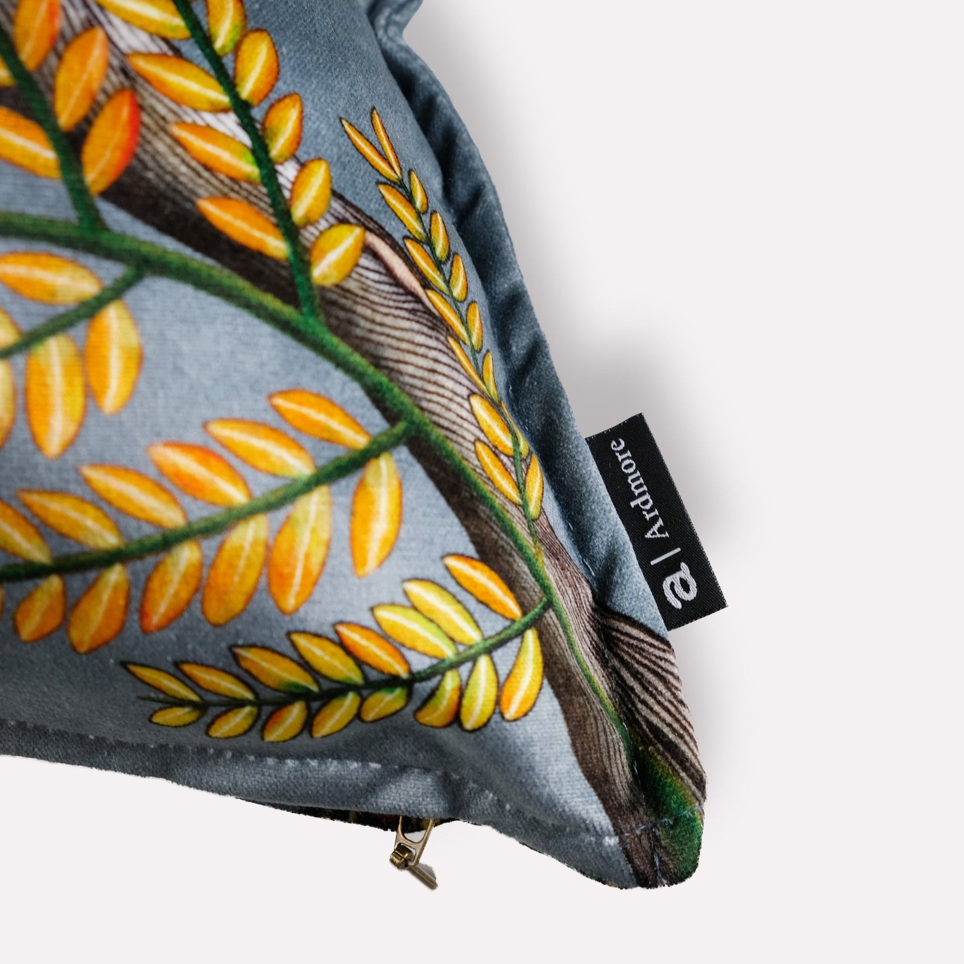 Side view of the Thanda Pangolin Park Ash Velvet Cushion Cover, highlighting the intricate stitching and vibrant foliage pattern along the edges.