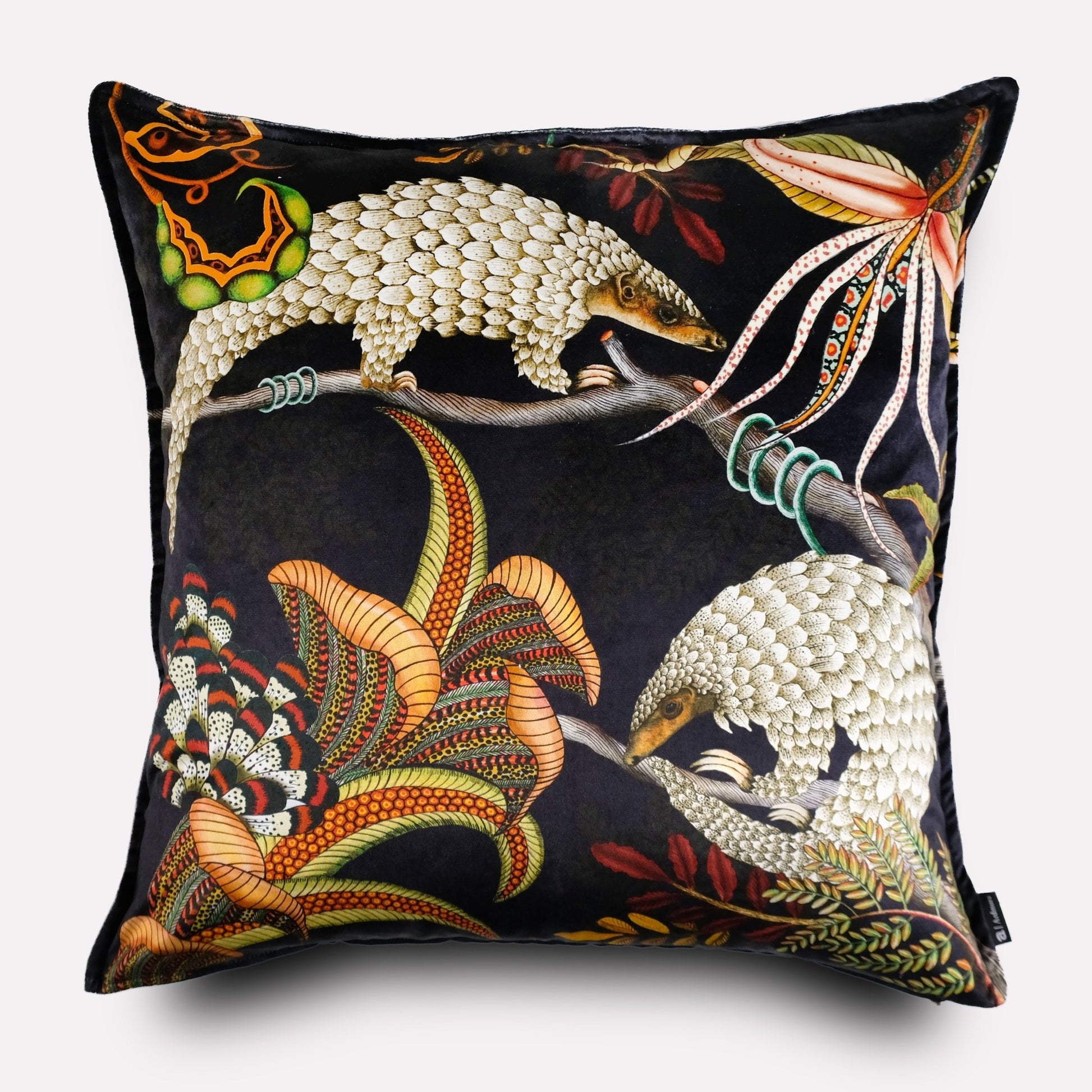 Front view of the Thanda Pangolin in Night Velvet Cushion Cover, featuring golden pangolins and vivid foliage on a luxurious black velvet base.