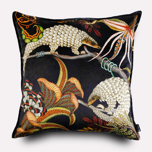 Front view of the Thanda Pangolin in Night Velvet Cushion Cover, featuring golden pangolins and vivid foliage on a luxurious black velvet base.