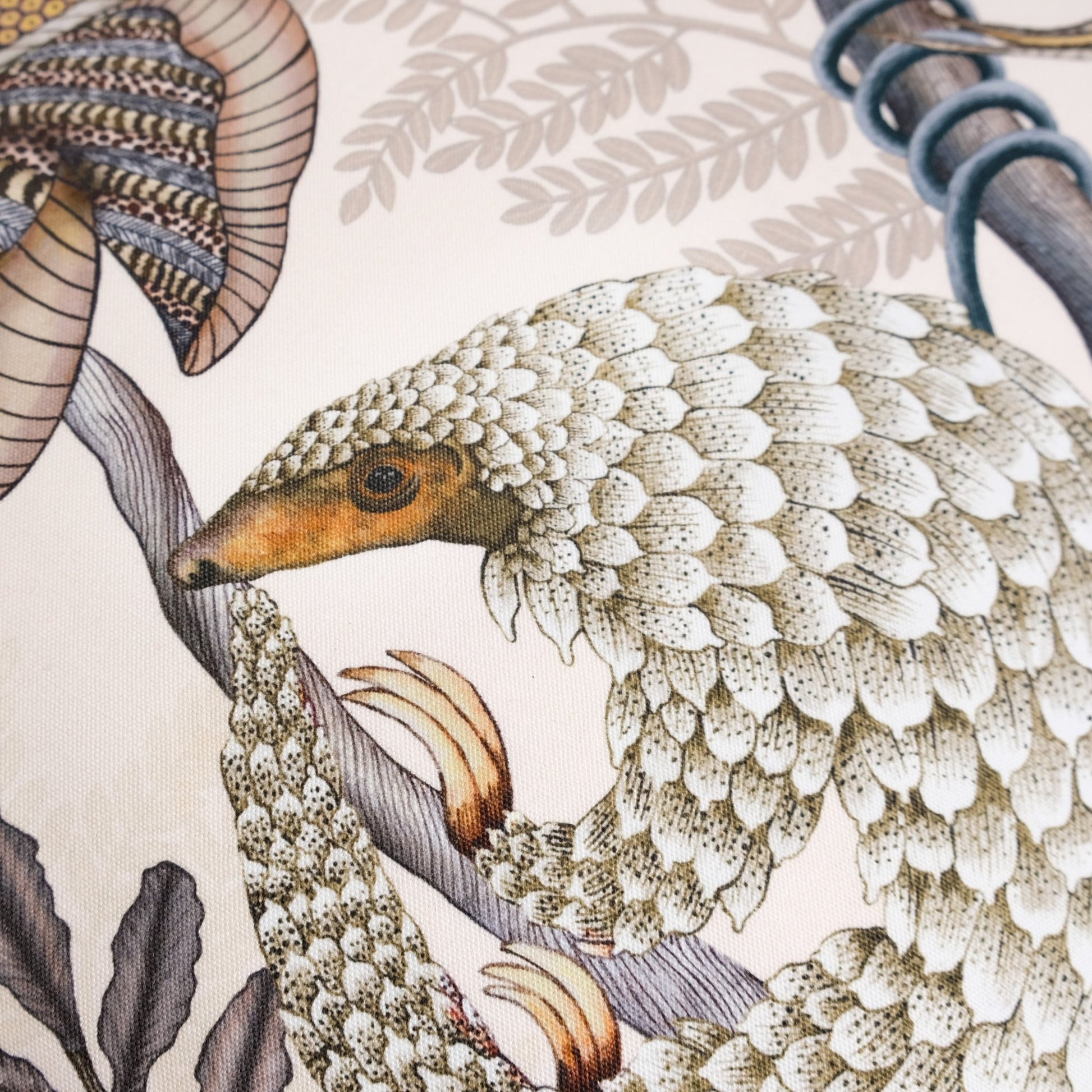 Side angle of the Thanda Pangolin in Pearl Cotton Cushion Cover, showcasing the intricate stitching and smooth texture of the premium cotton material.