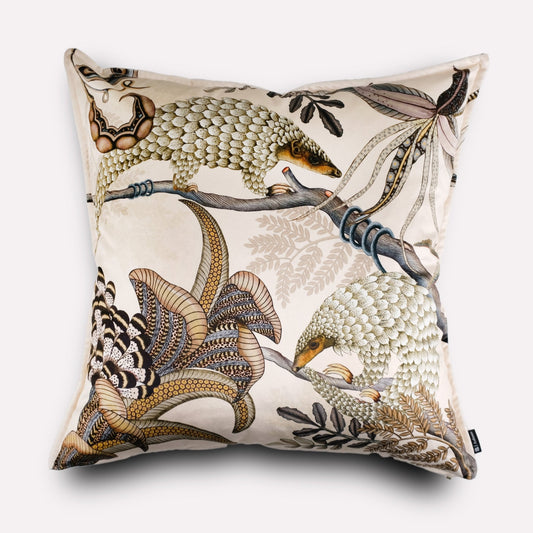Front view of the Thanda Pangolin Park Pearl Velvet Cushion Cover, featuring a beautifully detailed pangolin design in neutral tones, accented by delicate foliage on a soft pearl velvet background.