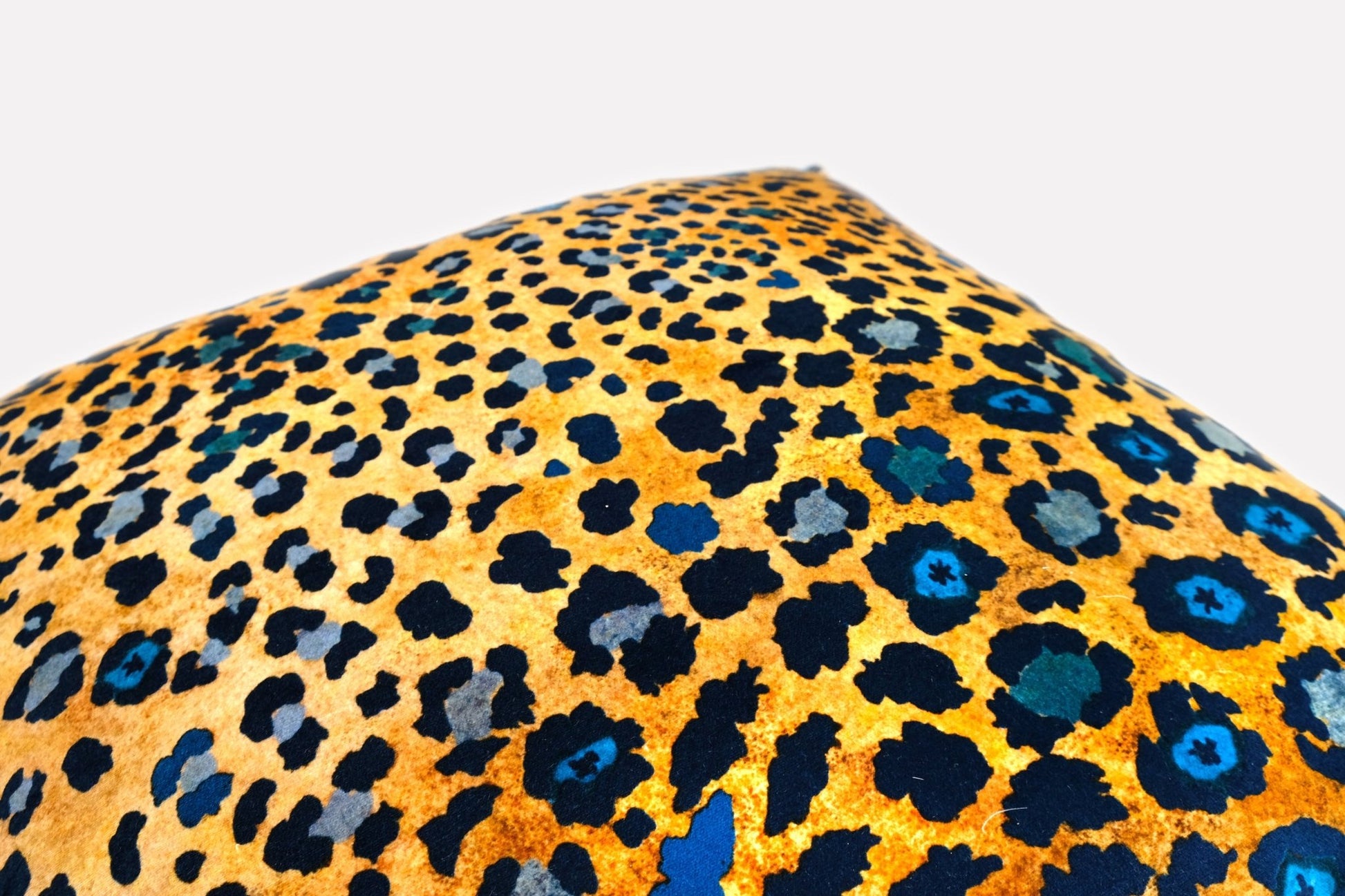 Angled view of the Safari Spot Midnight Velvet Cushion Cover, showcasing the vibrant colours and plush velvet texture.