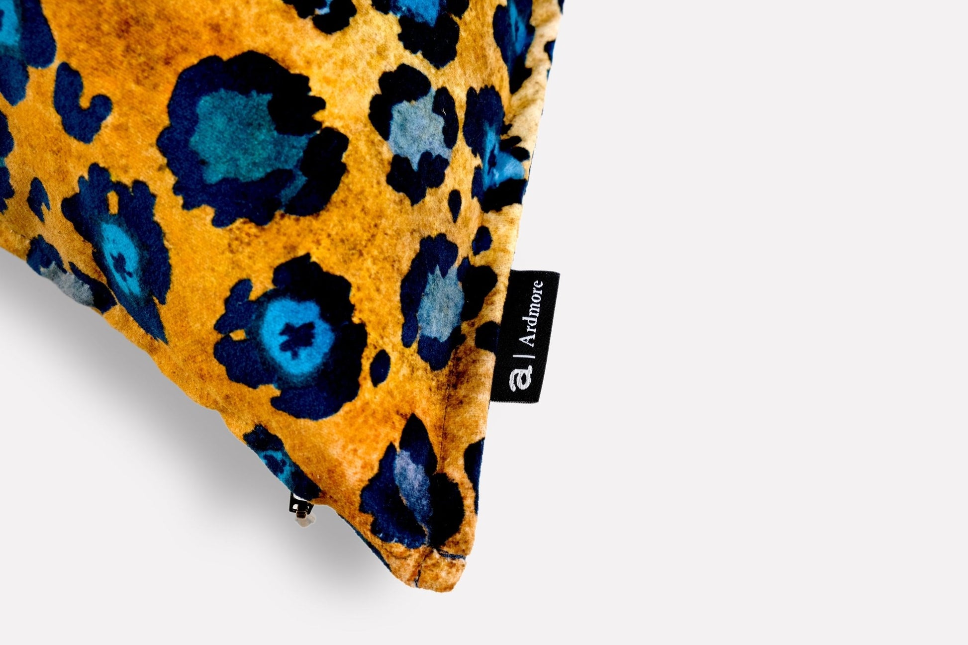 Close-up of the Safari Spot Midnight Velvet Cushion Cover's fabric, capturing the intricate details and rich blue and gold pattern.
