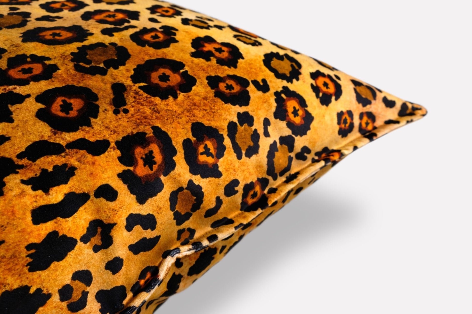 Side angle of the Safari Spot Gold Velvet Cushion Cover, showcasing the rich texture and vivid leopard-print pattern.