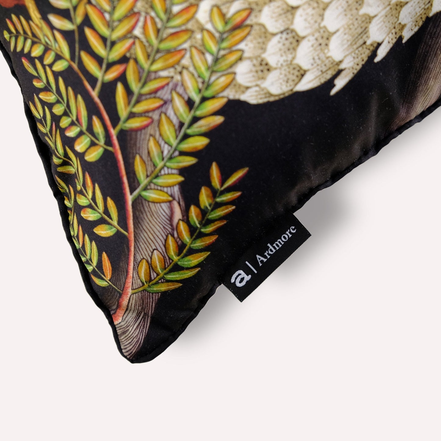 Close-up of the Thanda Pangolin in Night Silk Cushion Cover, highlighting the intricate stitching and the luxurious silk finish.