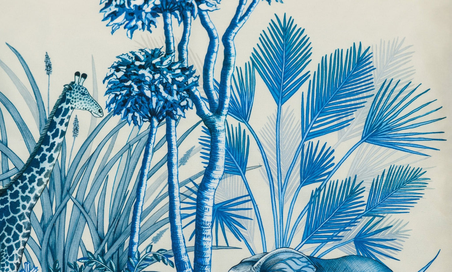 A detailed view of the cushion’s botanical elements, highlighting the delicate blue tones and intricate hand-drawn foliage.