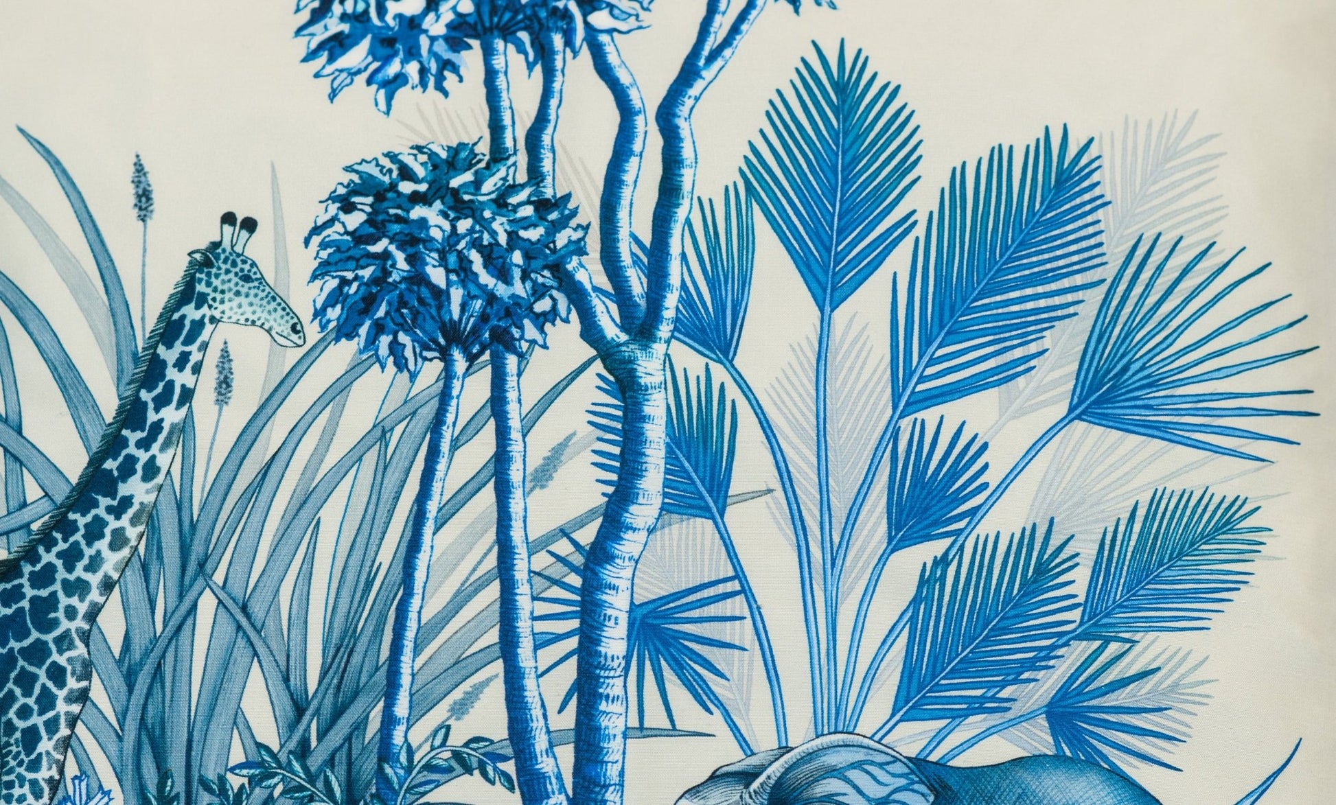 A detailed view of the cushion’s botanical elements, highlighting the delicate blue tones and intricate hand-drawn foliage.