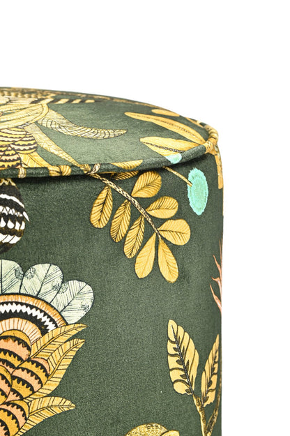 Side view close-up of the Ardmore Camp Critter Dusk Velvet Pouffe, showcasing the luxurious fabric texture and detailed golden embroidery of African-inspired wildlife designs.