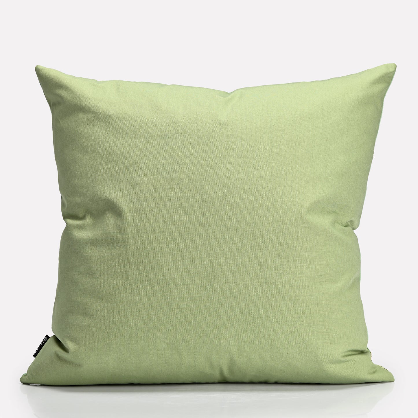 A plain light green fabric backing, providing a contrast to the detailed front design.