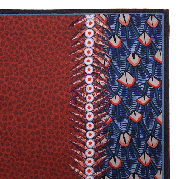 A zoomed-in view of the Ardmore Feather napkin in Royal Red, showcasing the bold feather-inspired design and fine textile details.