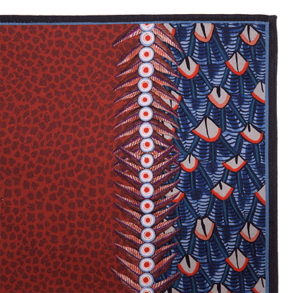 A zoomed-in view of the Ardmore Feather napkin in Royal Red, showcasing the bold feather-inspired design and fine textile details.
